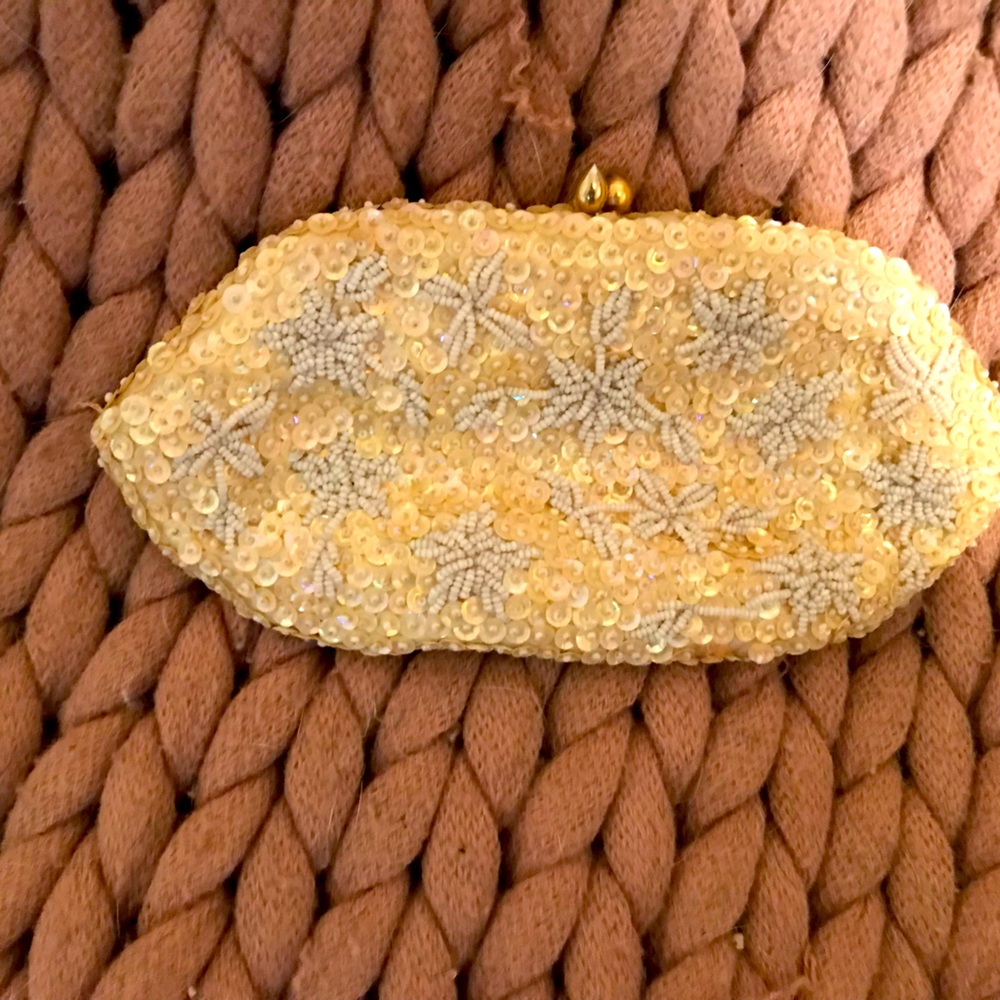 Cream evening clutch with gold accents